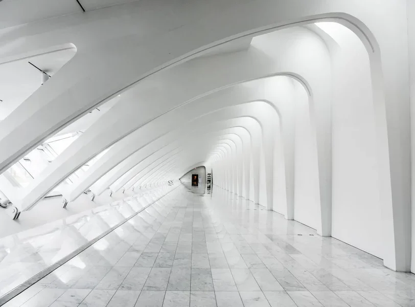 A white hallway extending to a focal point in the distance